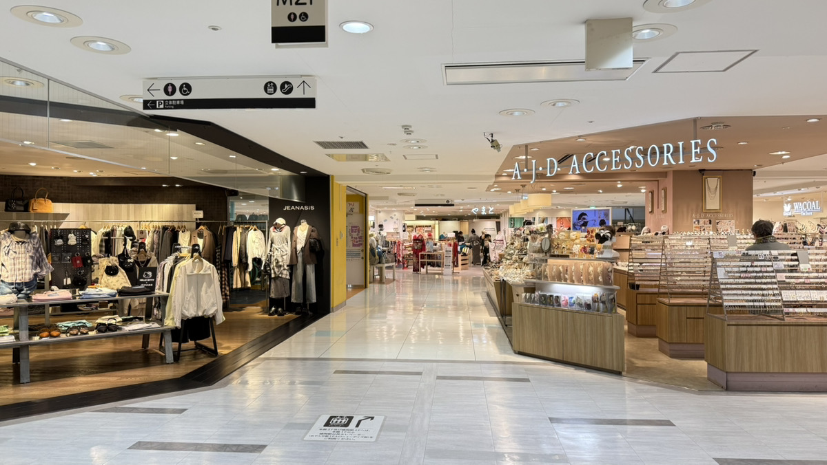 4.階段を下りていただくと、左手に「JENASIS」さんがございます。「JENASIS」さんを左手に通り過ぎ、そのまま通路をまっすぐお進みください。